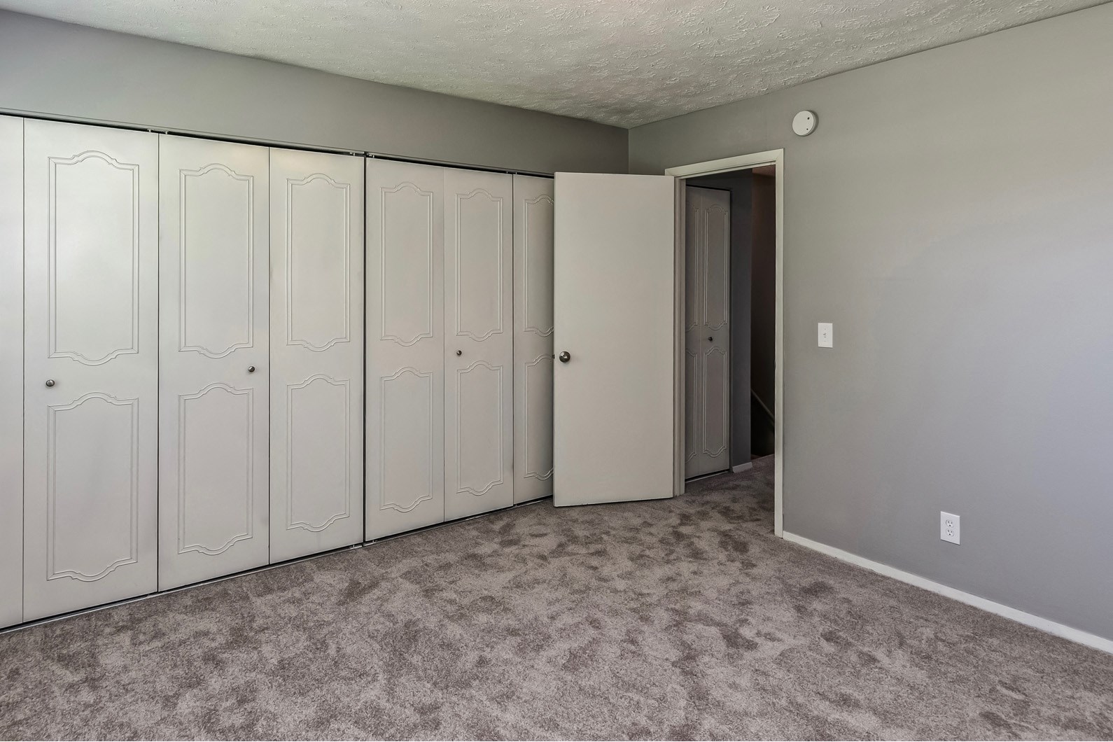 Carpeted bedrooms with large closets at Terrace Garden Townhomes
